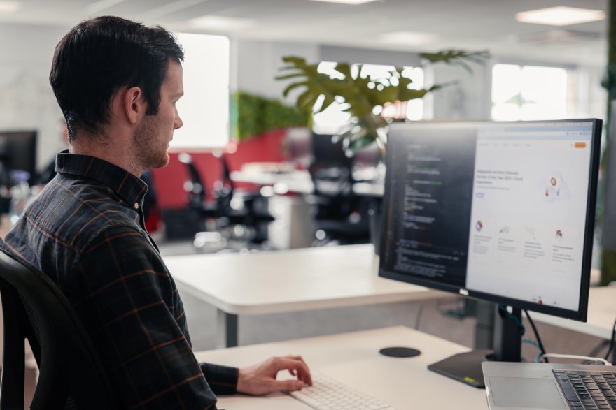 Web developer sitting at his desk working
