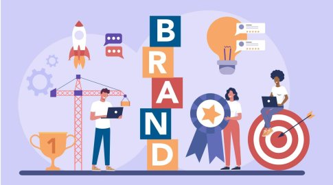 Illustration of people building a brand, represented by blocks spelling "BRAND," with a trophy, rocket, speech bubbles, gears, crane, giant light bulb, award ribbon, and person sitting on a target with an arrow.