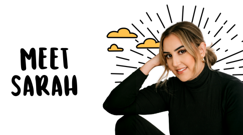 A woman with light brown hair pulled back, wearing a black turtleneck, sits smiling with her elbow resting on her knee. To her left, large black text reads "MEET SARAH." Behind her are illustrated yellow clouds and radiating black lines on a white background.
