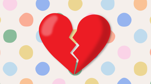 A large red broken heart with a jagged crack down the middle, set against a background of colorful pastel polka dots.